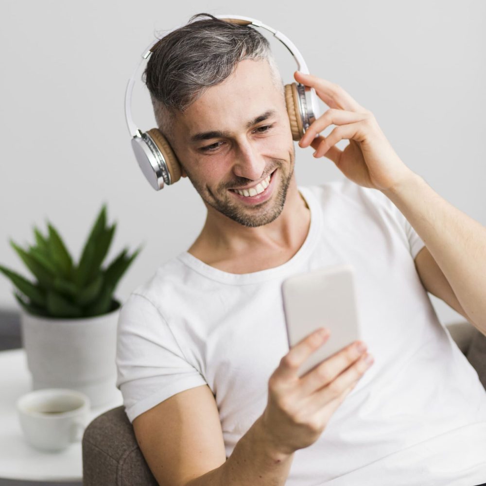 front-view-guy-with-headphones-smiling-his-phone (1) (1)